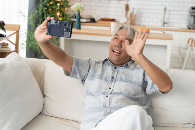 Asian man making video call with family