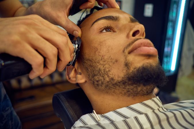 Anonymous hairstylist doing a haircut