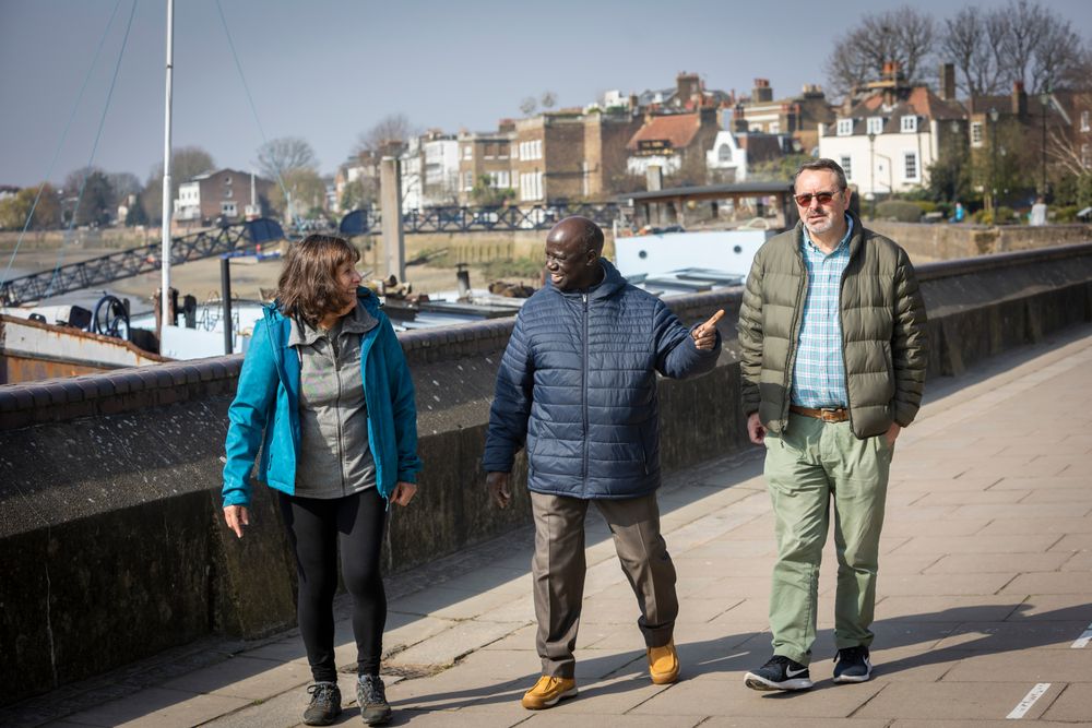 Smiling multi-ethnic group of older adults going for a stroll outside