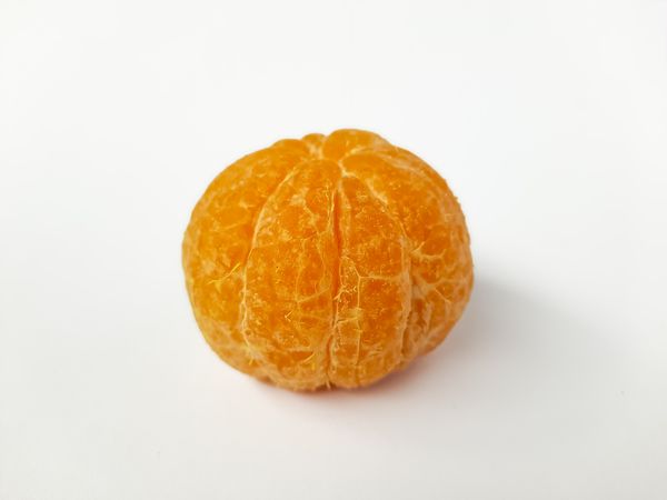 Closeup of Peeled Mandarin Orange on Plain Background