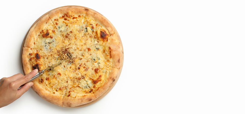 Female hand cut cheese pizza on neutral background