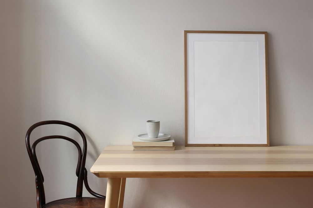 Cup of coffee, books on wooden table
