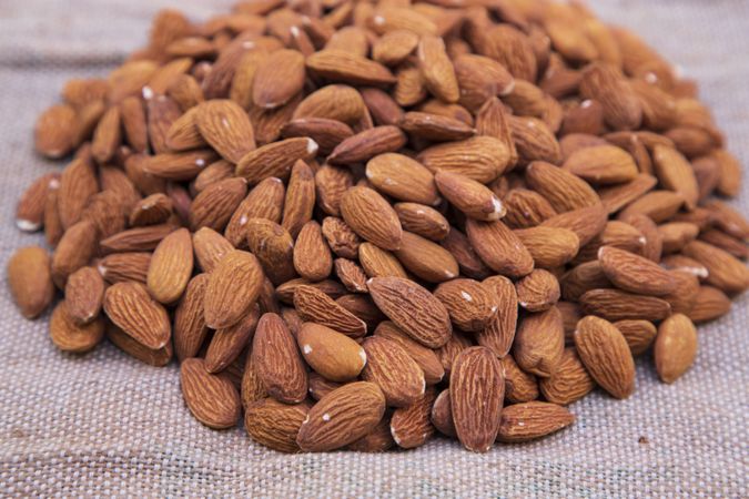 Some almonds on brown Jute fiber fabric