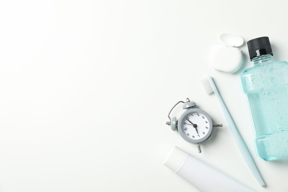 Tools for dental care on light background, space for text
