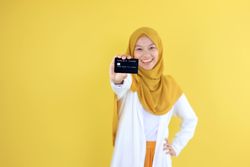 Smiling of Young Muslim Woman in Hijab Hold Credit Card.