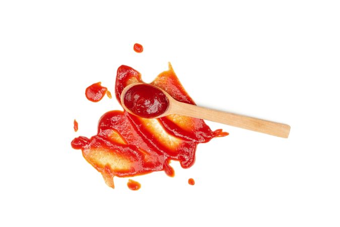 Wooden spoon and sauce isolated on blank background
