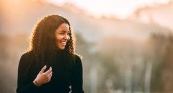 Smiling Black woman with curly hair