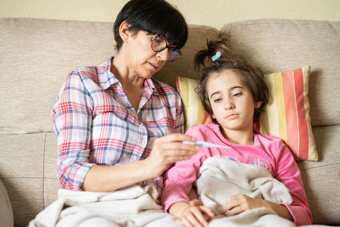 Woman nursing her sick daughter