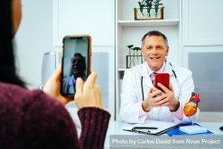 Physician taking video call with patient from his office 5QjQV4