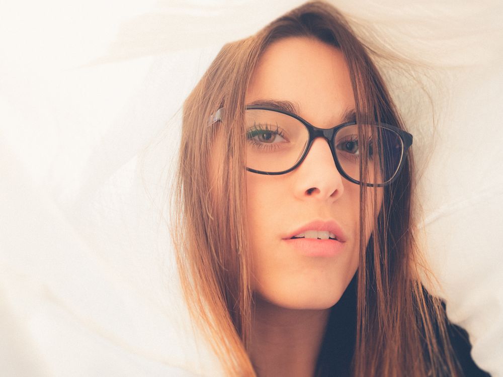 Woman in eyeglasses between textile