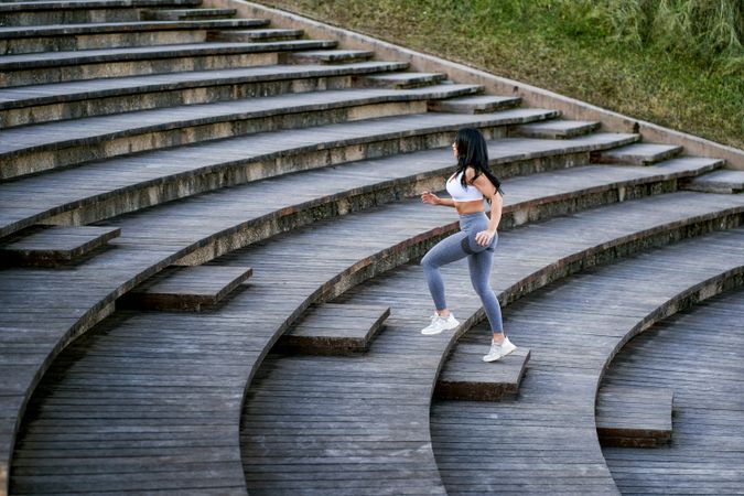 young athletic woman running up a flight of stairs