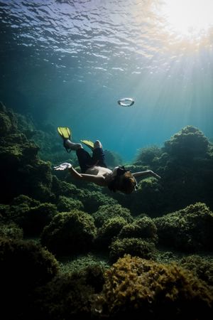 Man swimming on back underwater