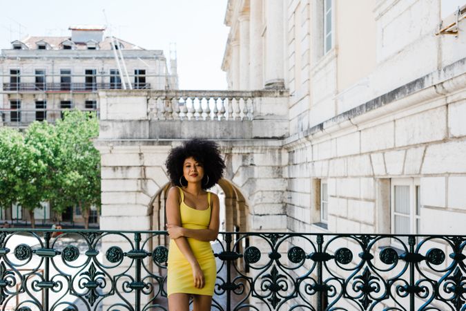 Stylish female leaning on railing outdoors