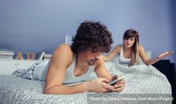 Man using smartphone during quarrel with woman 48BGyY