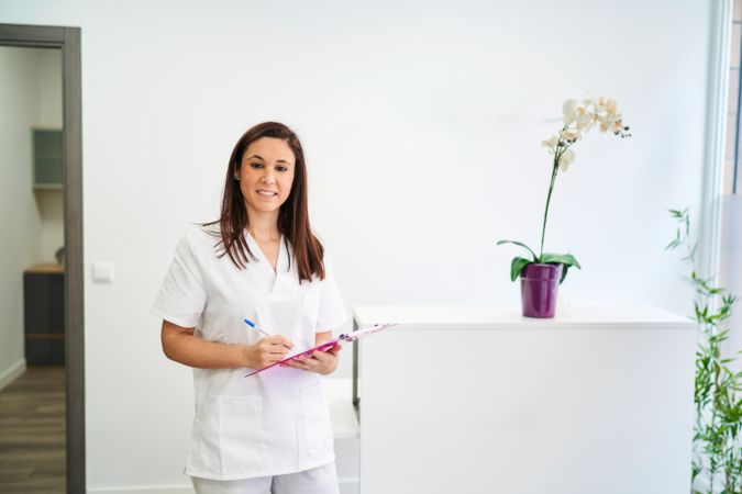 physiotherapist at the clinic's reception desk