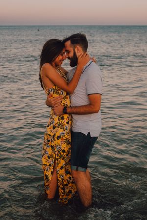 Loving couple embracing happily on sandy beach