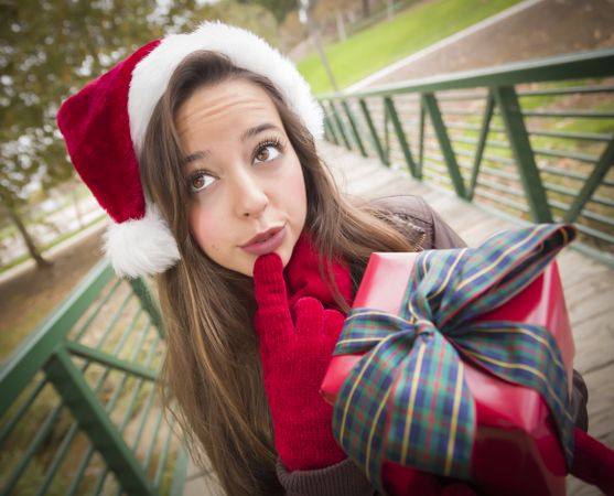 Woman in a Santa Hat with Wrapped Gift