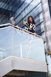 Female artist looking down from terrace