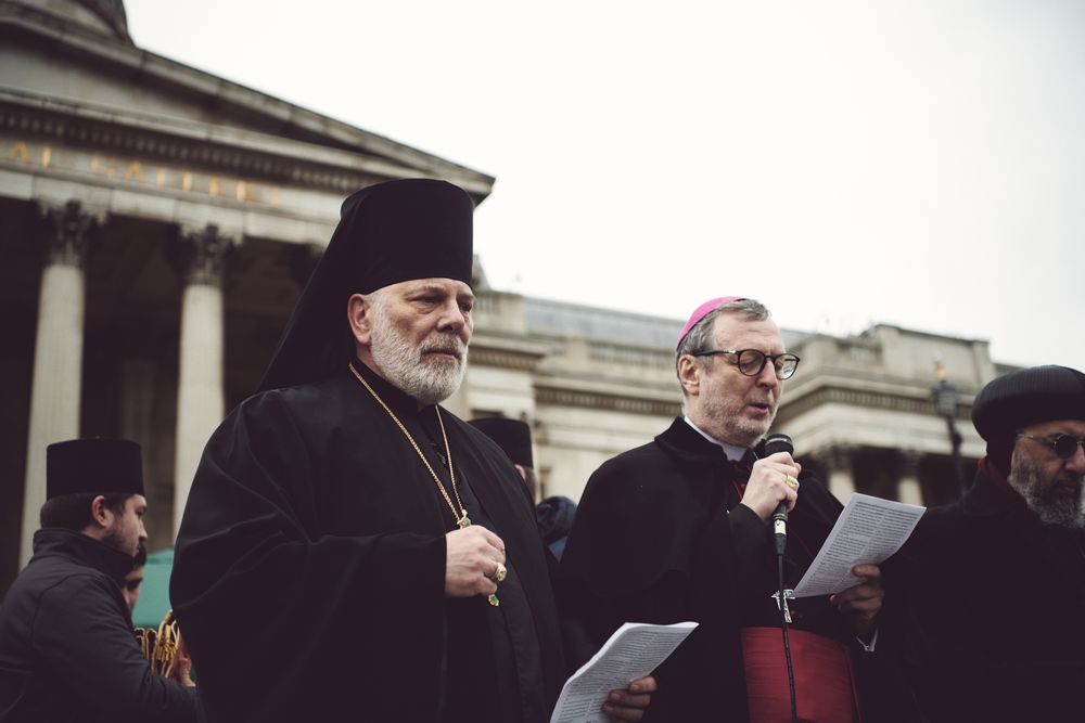 London, England, United Kingdom - March 5 2022: Two men in religious robes reading from paper