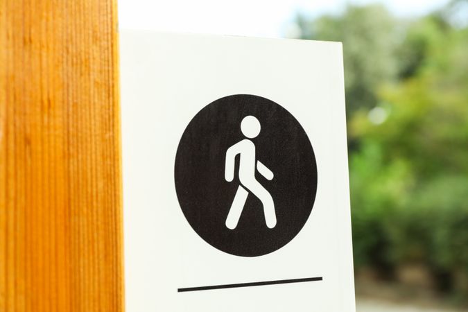 Sign for pedestrians in park, close up