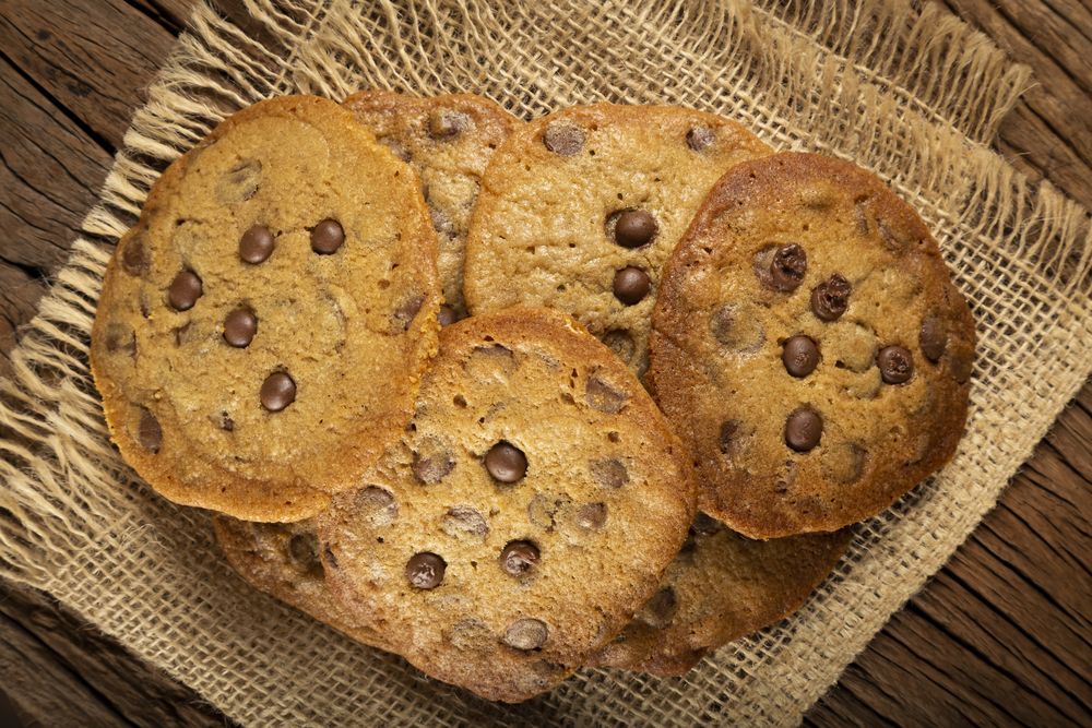 Delicious chocolate cookies on wooden table.