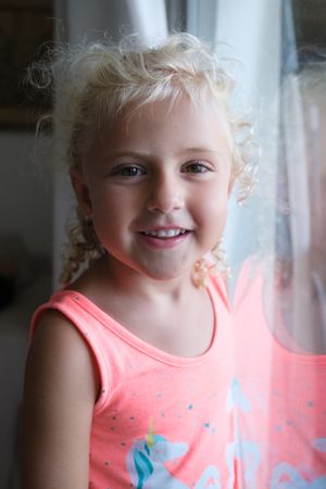 Cheerful little girl looking at camera