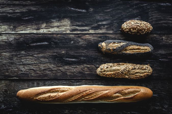Assorted gold homemade bread on dark wood background