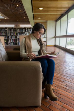 Woman in glasses reading a book