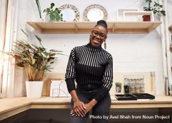 Smiling Black woman pictured in a trendy office bYW9Y5