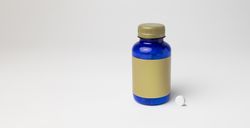Mockup of a magnesium bottle with a pill on the side, food supplement, closed, blue color, with label