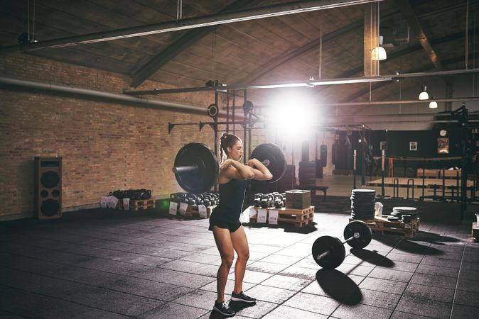 Woman heavy lifting in spacious gym