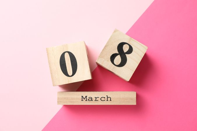 8 march wooden calendar on two tone background, space for text