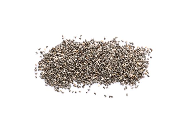 Heap of chia seeds isolated on studio background