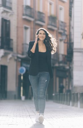 Young female walking with smartphone