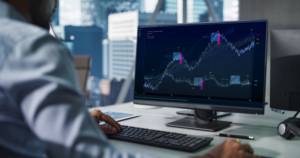Hedge Fund Office: Indian Financial Analyst Using Computer with Display Showing Real-Time Stocks