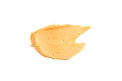 Creamy peanut butter isolated on bright background. A traditional product of American cuisine