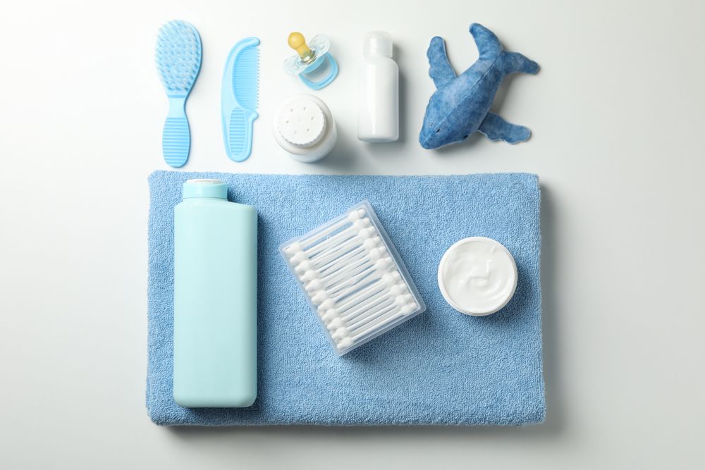Flat lay with baby hygiene accessories on light background