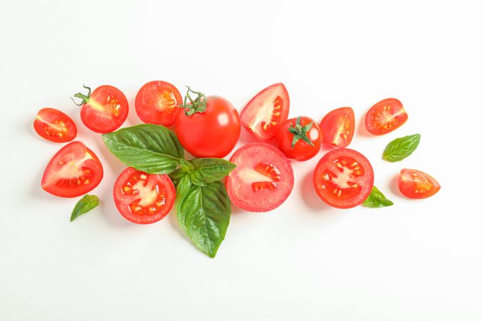 Flat lay composition with fresh cherry tomatoes and basil on blank background, space for text. Ripe vegetables