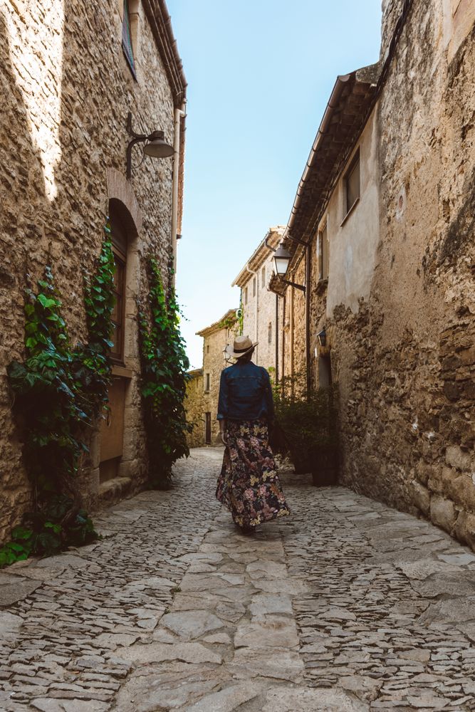 Woman walking in a narrow path in a village