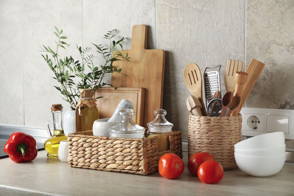 Kitchen table with different supplies and vase with plant
