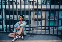 Sad Asian man sitting and drinking alcohol