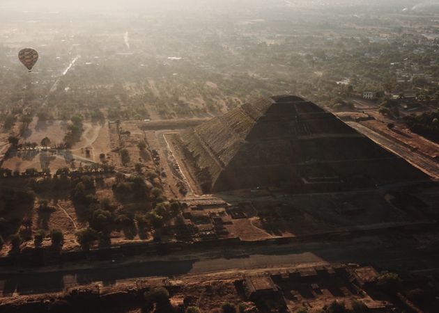 View of one hot air balloon in next to pyramid in Teotihuacan Valley
