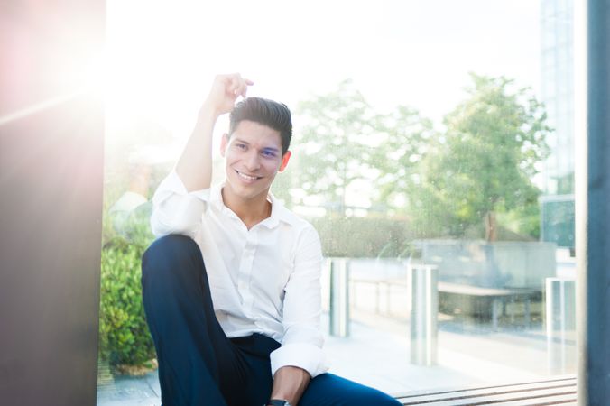 Smiling modern man on bench