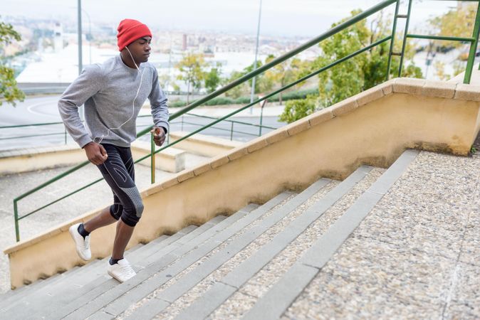 Fit male working out by sprinting upstairs