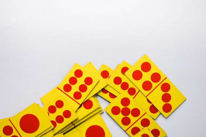 Top view of red and yellow domino cards with space for text