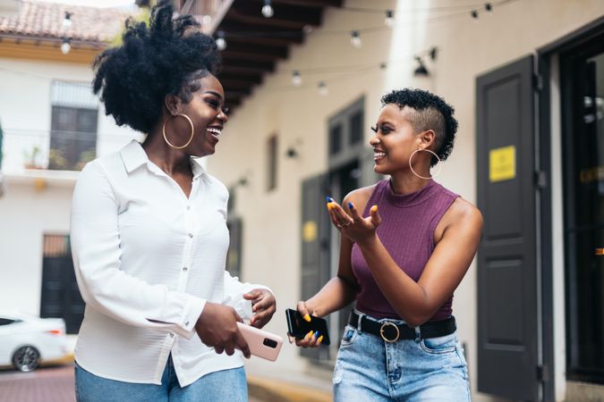 Black women talking and laughing walking in the city