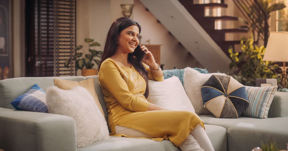 Indian Woman Engaged in a Lively Phone Call at Home