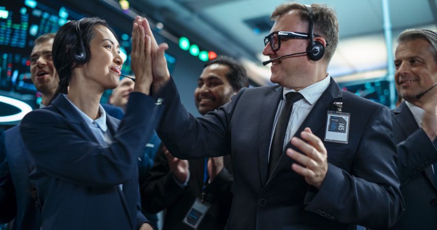 Team of Happy Investment Bankers Applauding, Celebrating and Congratulating Each Other on a Profitable Trading Day.
