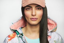 Close-up of confident woman pictured in colorful printed floral hoodie