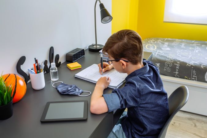 Teenager doing homework in his room
